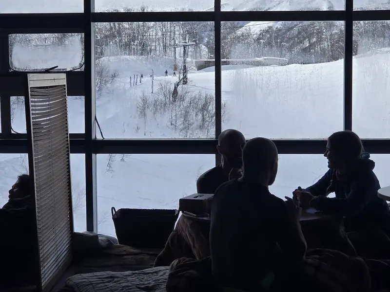 The piste and lift line seen from inside the warm indoor room