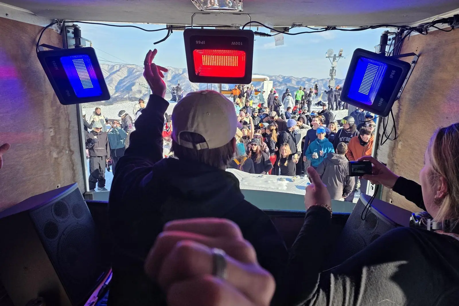 The crowd seen from inside the booth under the heat lamps