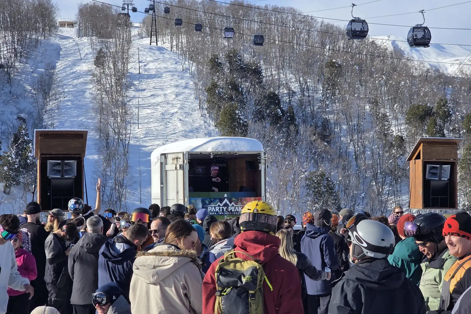 A packed crowd at the Party Peak stage under the Iwatake gondola line