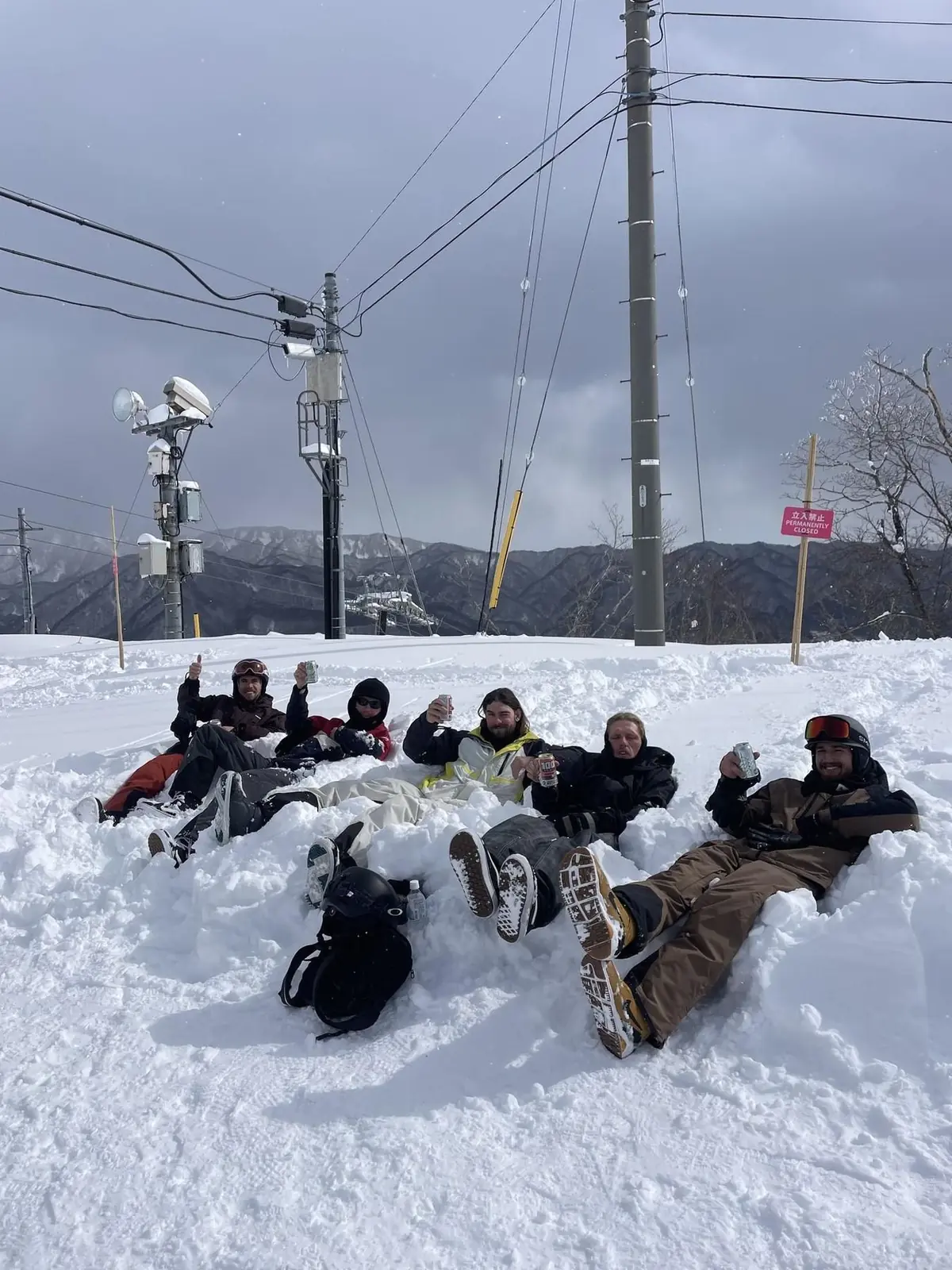 The crew sitting out on the snow together