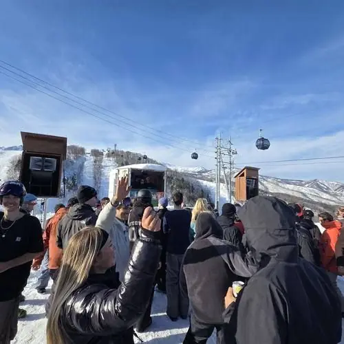 The crowd packed in front of the booth on a bluebird day