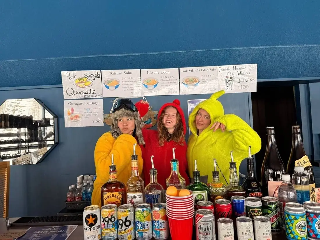 The crew in costume behind the bar with the drinks lined up