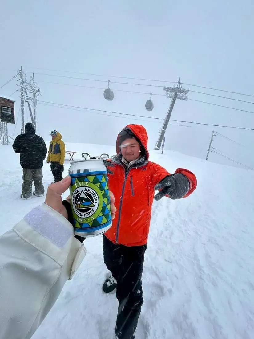 A cold one in hand with the snow coming down