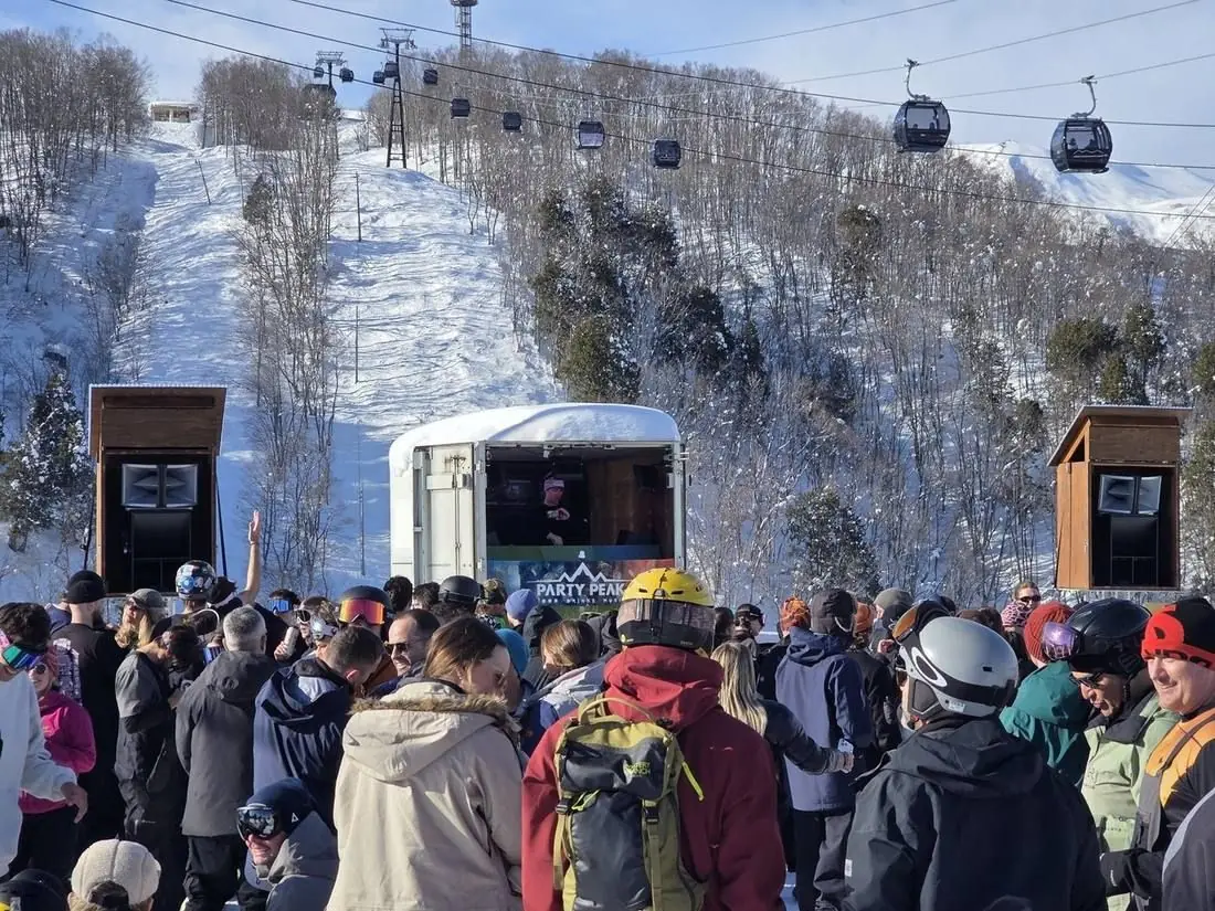The crowd packed around the booth under the Iwatake gondola line