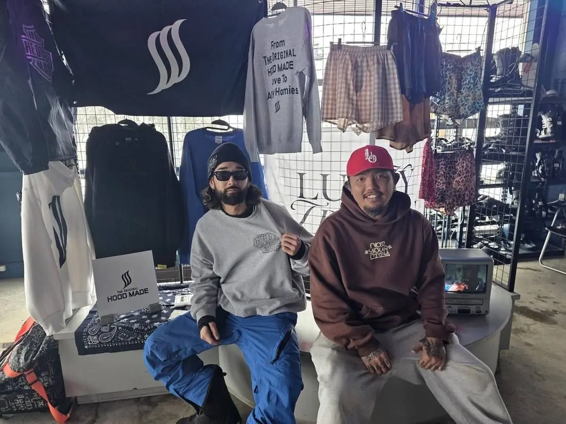 Two riders at the Party Peak merch tent