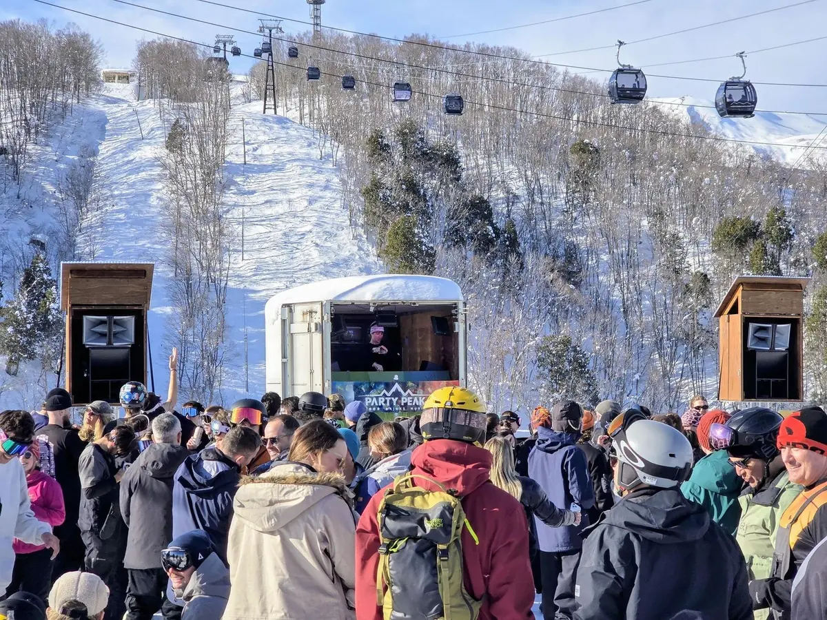 The crowd packed in front of the outdoor container stage and speaker towers